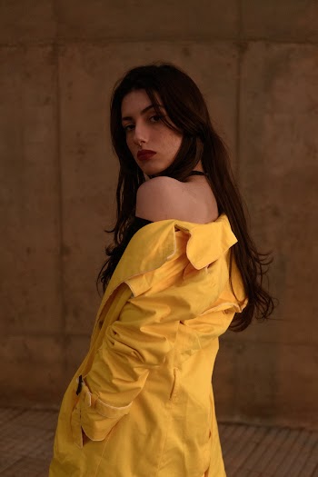Shallow Focus Photo of Woman in Yellow Coat