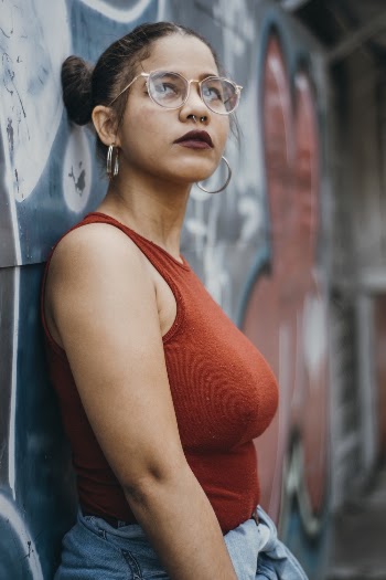 Shallow Focus Photo of Woman Leaning on Wall