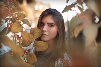 Shallow Focus Photo of Woman Near Leaves