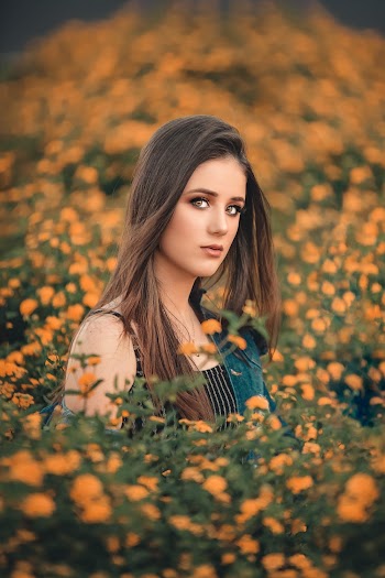 Shallow Focus Photo of Woman on Flower Field
