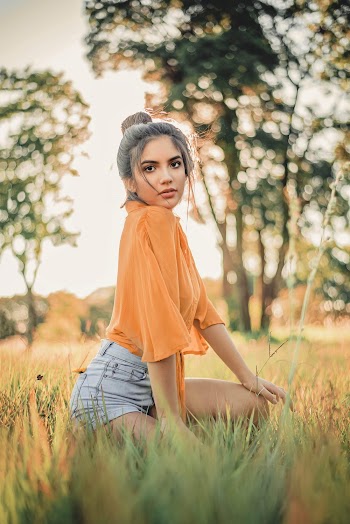 Shallow Focus Photo of Woman on Grass Field