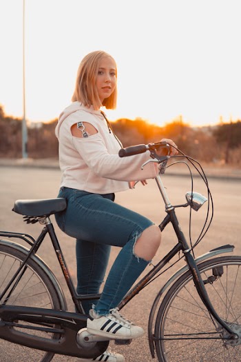 Shallow Focus Photo of Woman Riding Bike
