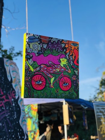 Shallow Focus Photo of Woman Riding Bike Painting
