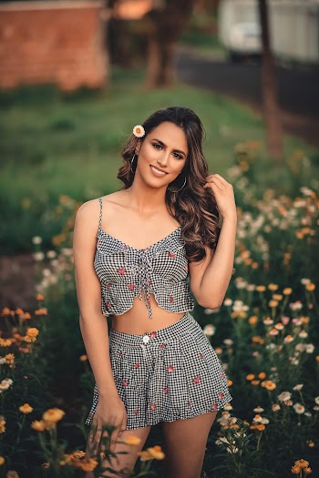 Shallow Focus Photo of Woman Smiling While Standing on Flower Field