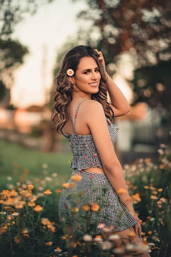 Shallow Focus Photo of Woman Smiling While Standing on Flower Field