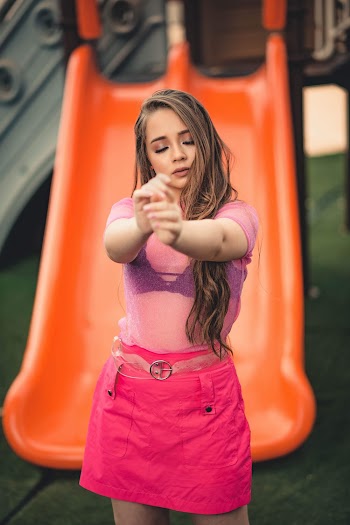 Shallow Focus Photo of Woman Standing Near Slide