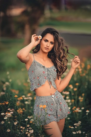 Shallow Focus Photo of Woman Standing on Flower Field