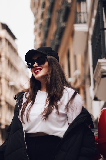 Shallow Focus Photo of Woman Wearing Black Curved Brim Cap