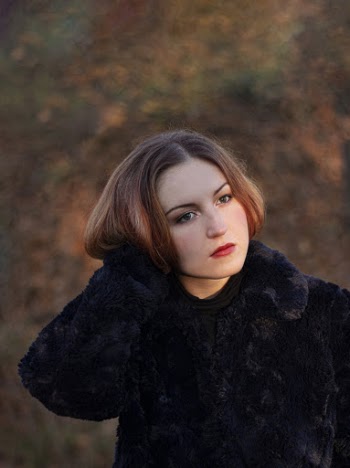 Shallow Focus Photo of Woman Wearing Black Long-sleeved Coat