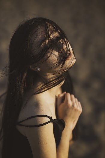 Shallow Focus Photo of Woman Wearing Black Spaghetti Strap Top