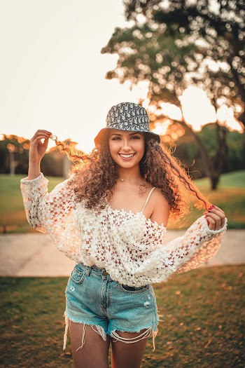 Shallow Focus Photo of Woman Wearing Blue Bucket Hat