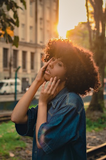 Shallow Focus Photo of Woman Wearing Denim Top