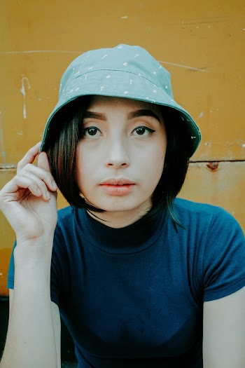 Shallow Focus Photo of Woman Wearing Gray Bucket Hat