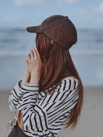 Shallow Focus Photo of Woman Wearing Striped Long Sleeves