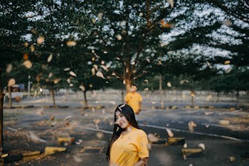 Shallow Focus Photo of Woman Wearing Yellow Shirt