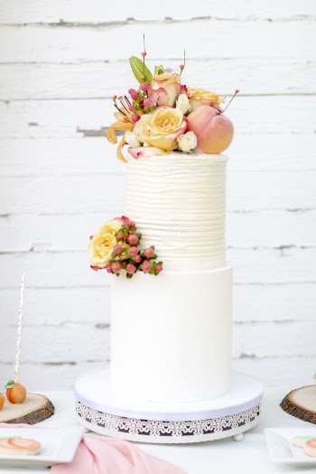 Shallow Focus Photo of Yellow and Pink Flowers on Two-tier Cake