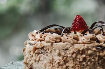 Shallow Focus Photography Cake With Red Strawberry on Top