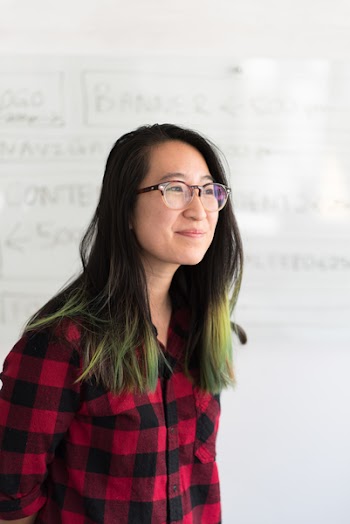Shallow Focus Photography of a Woman in Red and Black Checkered Dress Shirt