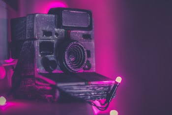 Shallow Focus Photography Of Black Instant Camera