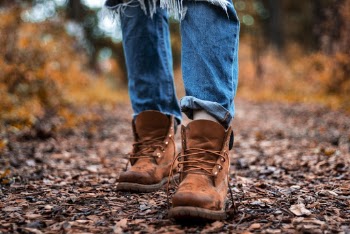 Shallow Focus Photography Of Blue Jeans And Brown Boots