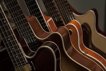 Shallow Focus Photography of Brown Guitars
