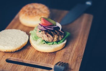 Shallow Focus Photography of Burger Sandwich Served on Brown Wooden Chopping Board