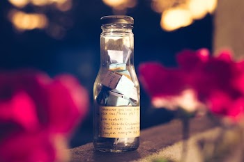 Shallow Focus Photography of Clear Glass Bottle