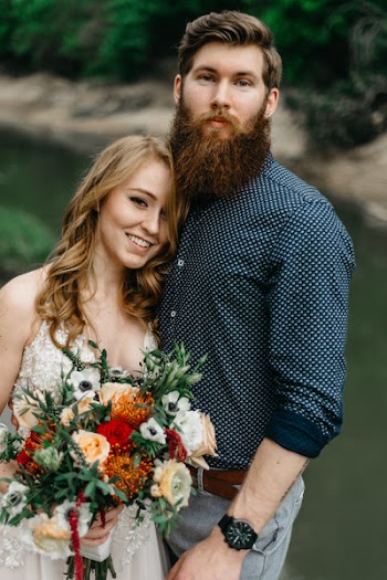 Shallow Focus Photography of Man and Woman Holding Bouquet