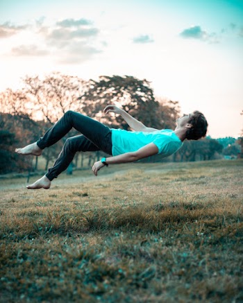 Shallow Focus Photography of Man Floating on Air