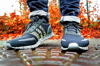 Shallow Focus Photography of Pair of Black Black-and-white Adidas Running Shoes