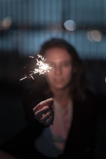 Shallow Focus Photography of Person Holding a Sparkler