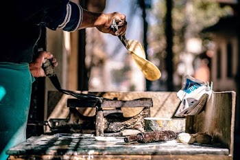 shallow focus photography of person holding pan and bread