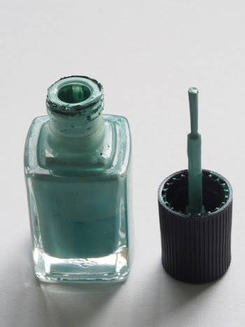 Shallow Focus Photography of Teal Nail Lacquer