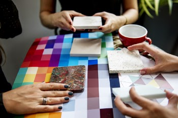 Shallow Focus Photography of Three People Holding Square Panels