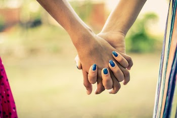 Shallow Focus Photography Of Two Person Holding Hands