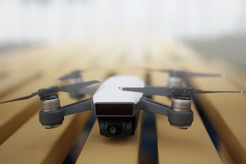 Shallow Focus Photography of White and Gray Quadcopter