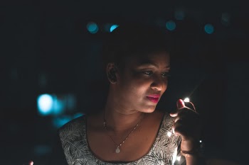 Shallow Focus Photography of Woman Holding String Light