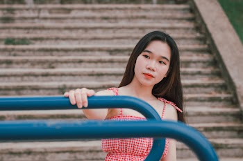 Shallow Focus Photography Of Woman in Red And White Spaghetti Strap Dress