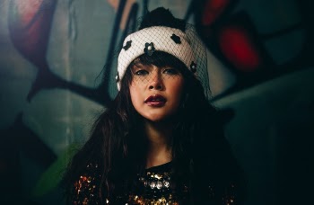 Shallow Focus Photography of Woman Near Wall With Graffiti