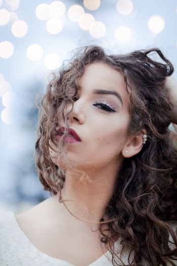 shallow focus photography of woman stroking her hair