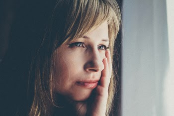 Shallow Focus Photography Of Woman Touching Her Left Cheek