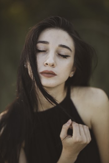 Shallow Focus Photography of Woman Wearing Black Sleeveless Top