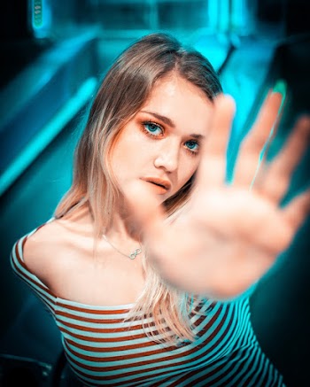 Shallow Focus Photography of Woman Wearing Stripe Top