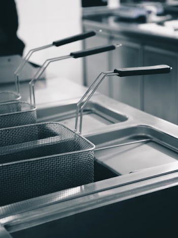 Shiny clean fryer in a restaurant kitchen 