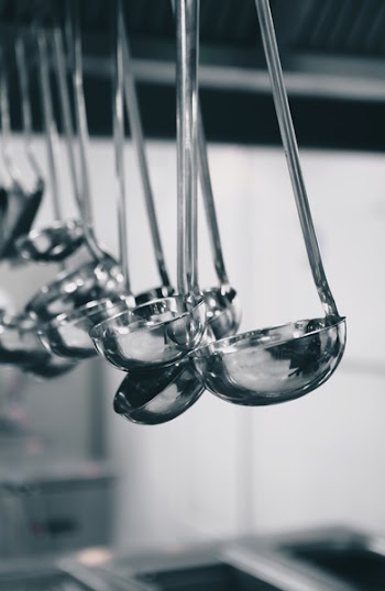 Shiny ladles in a restaurant kitchen 