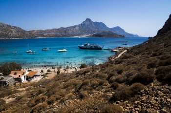 Ship and Boats on Sea Near Mountain