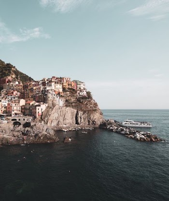 ship docked beside cliff