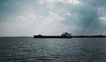 Ship Sailing Under Cloudy Sky