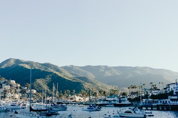 Ships on Body of Water Near Mountain