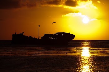 Shipwreck Silhouette At Sunset